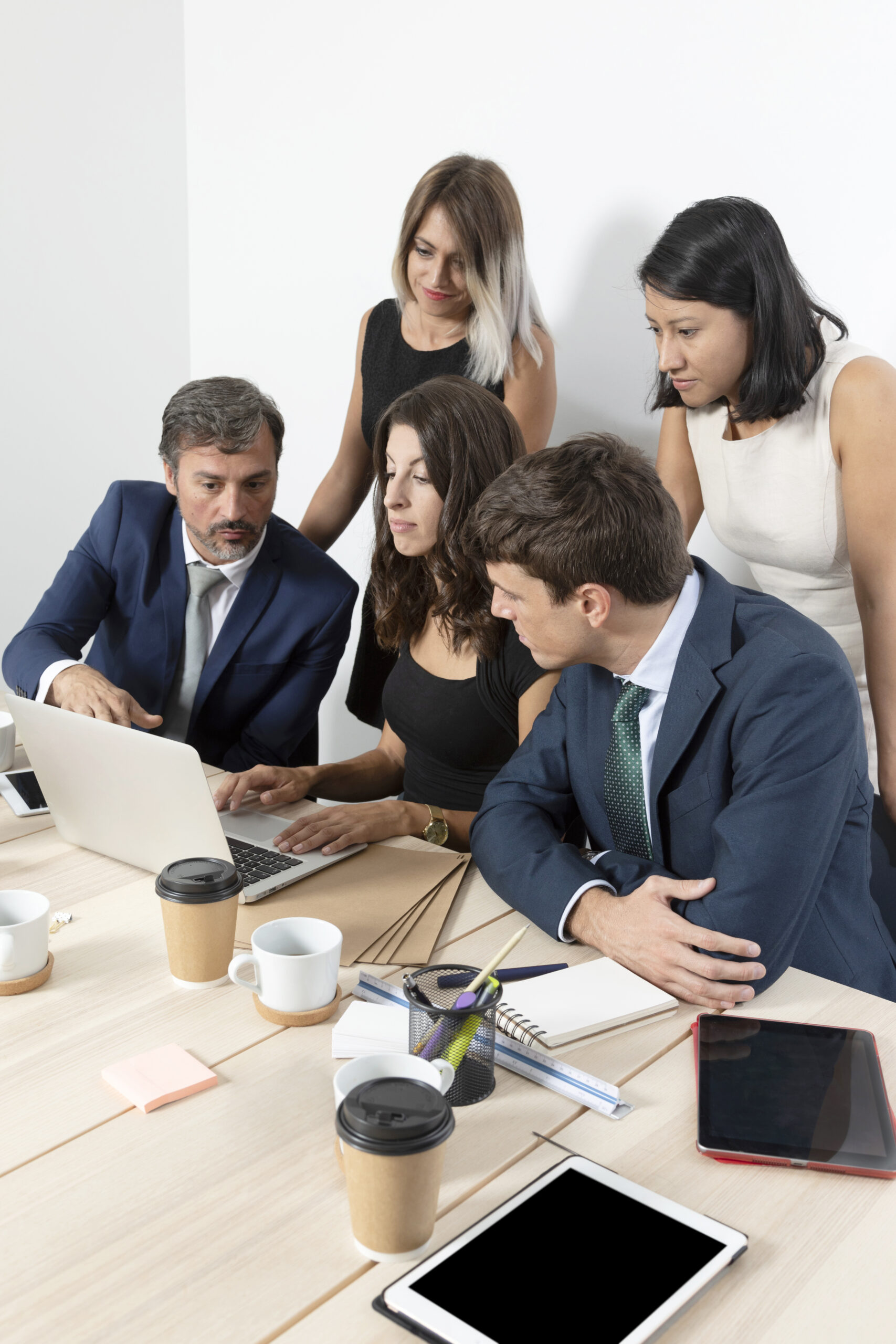 professional-employees-collaborating-medium-shot Group of Peoples looking in laptop